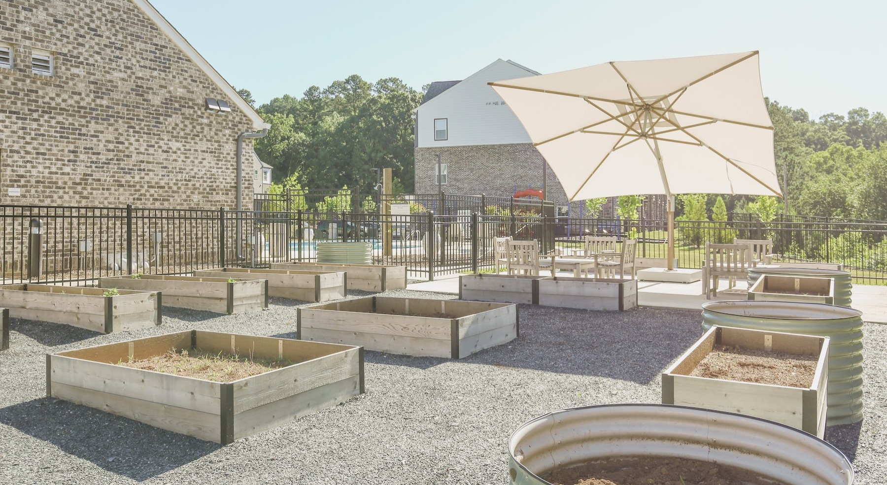 a garden area with boxes and an umbrella