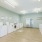 Laundry room with washer, dryers, and chairs