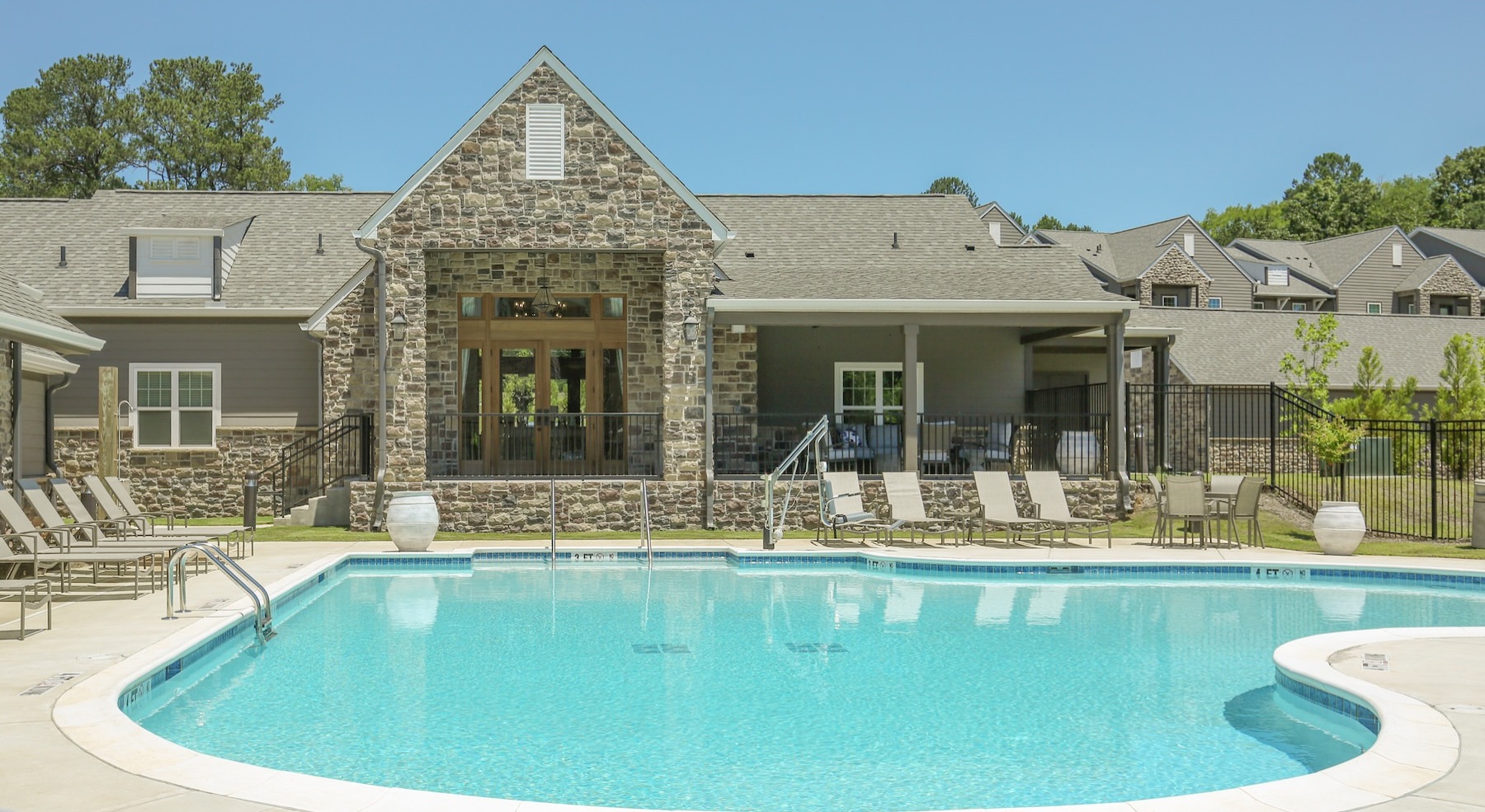 a swimming pool with lounge chairs