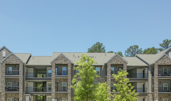 Apartment building exterior with view of rooftops