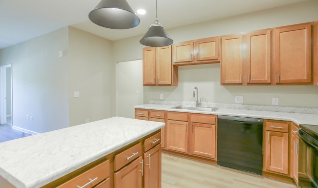 Kitchen with island and orange cabinets