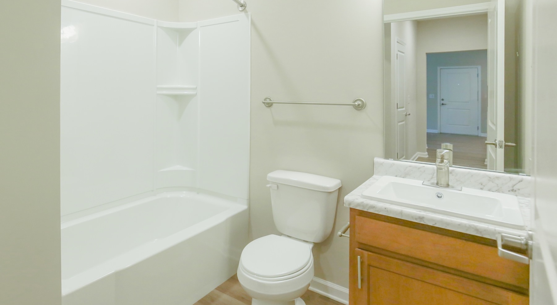 a bathroom with a tub, toilet and sink