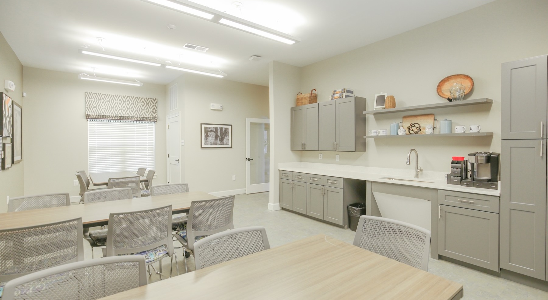 a co-working lounge with tables and chairs