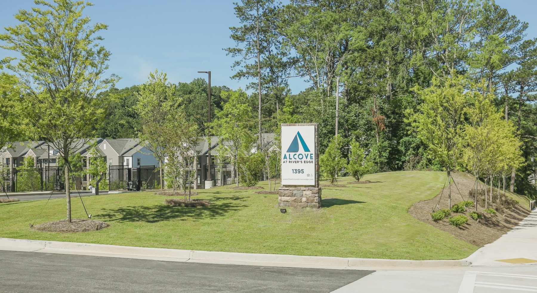 a neighborhood entrance with a sign